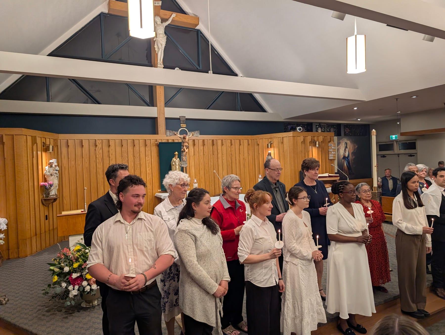 The congregation standing with candles inside St. Patrick’s during the Easter Vigil