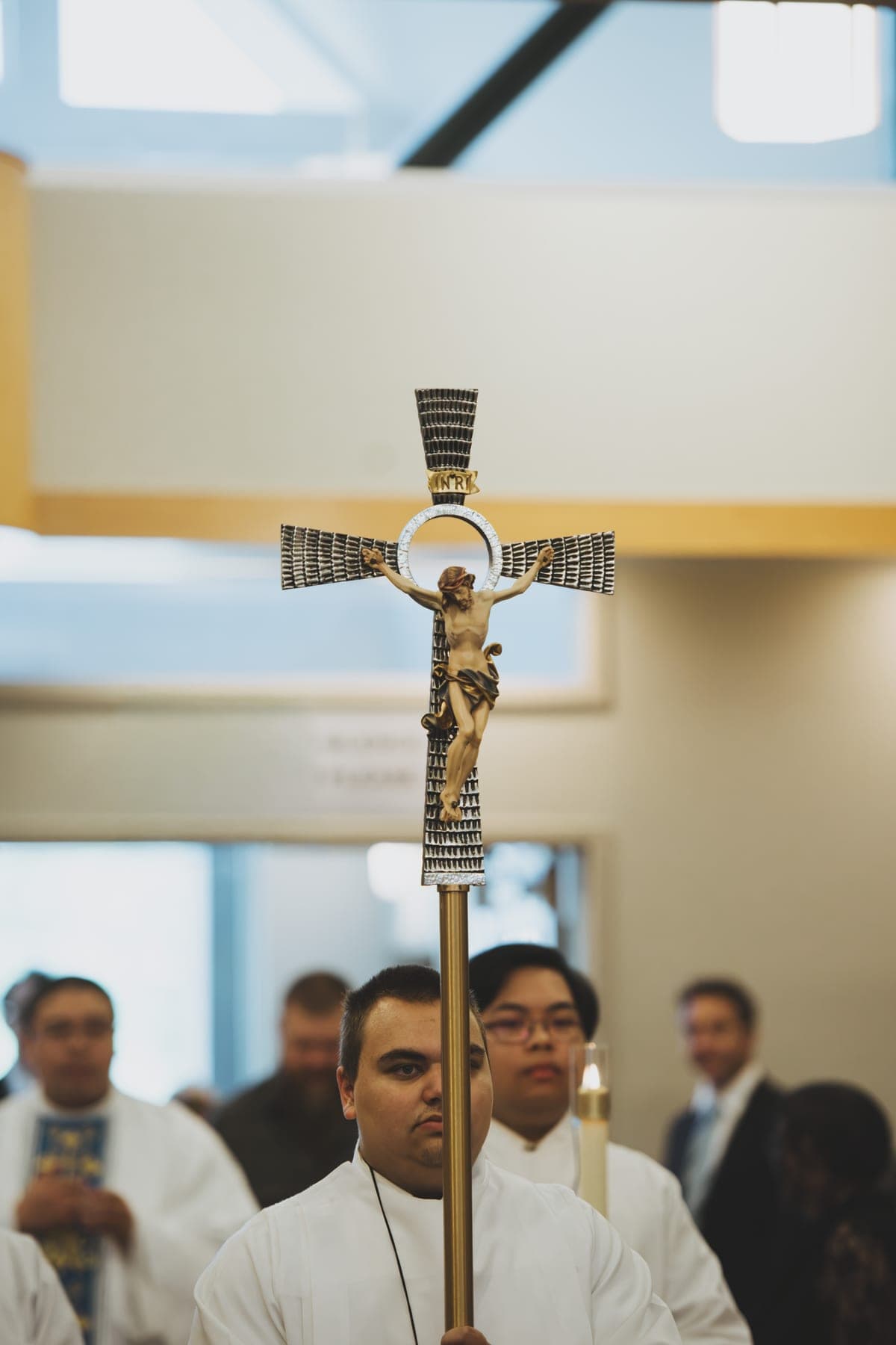 The processional cross raised above the congregation during the entrance procession